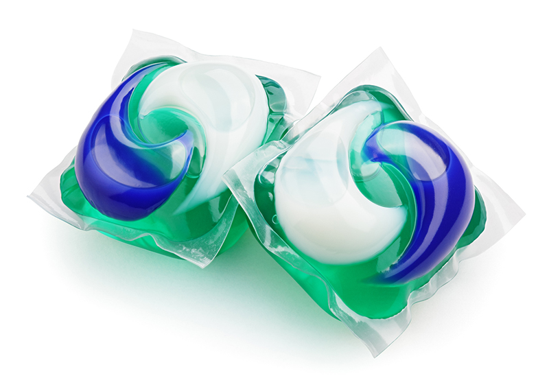 gel capsule pods with laundry detergent on white